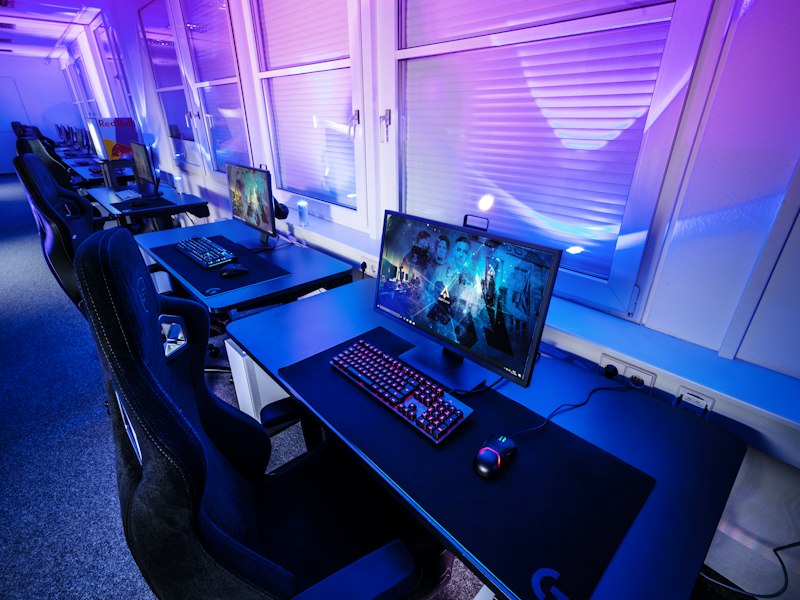 A game paused mid-scene on a screen in a softly lit room